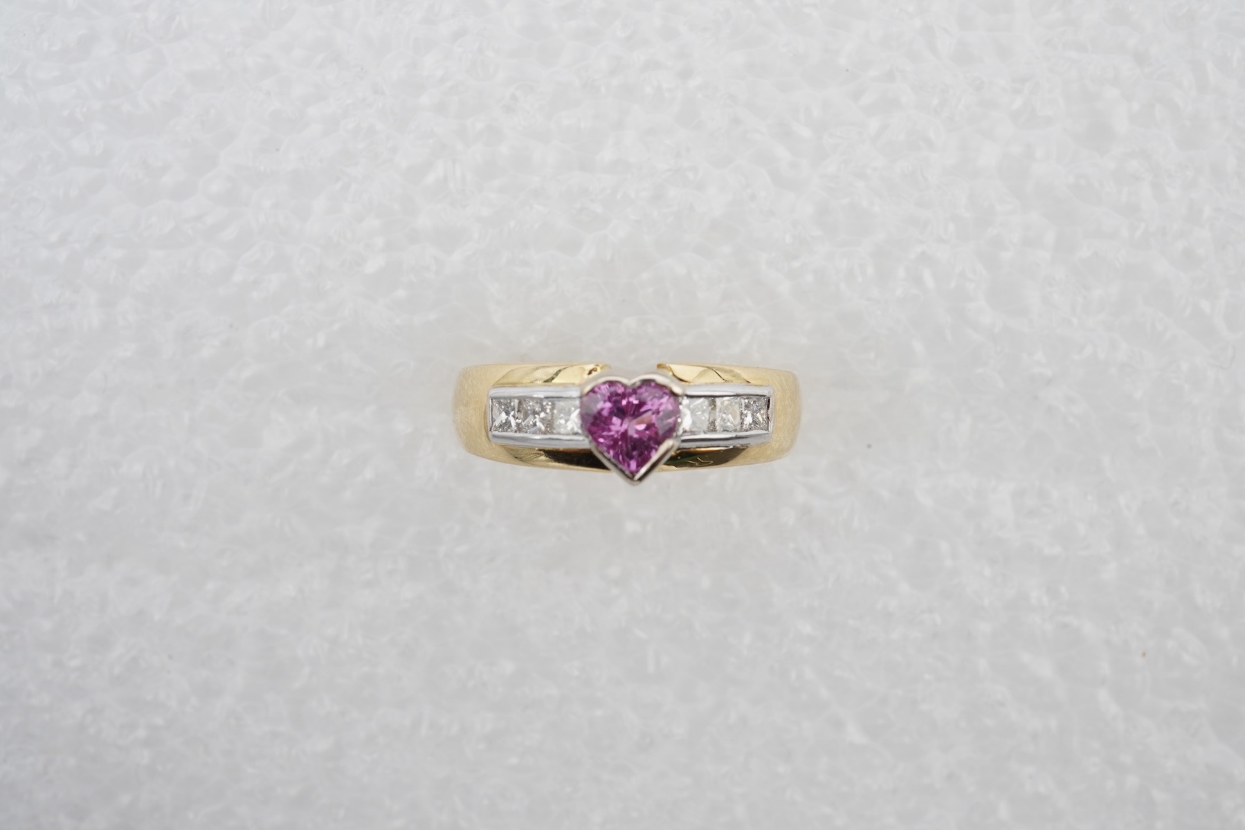 A pink sapphire and diamond ring